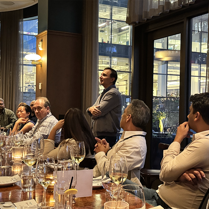 Executives in conversation around the dinner table at a past Incisiv Insights gathering