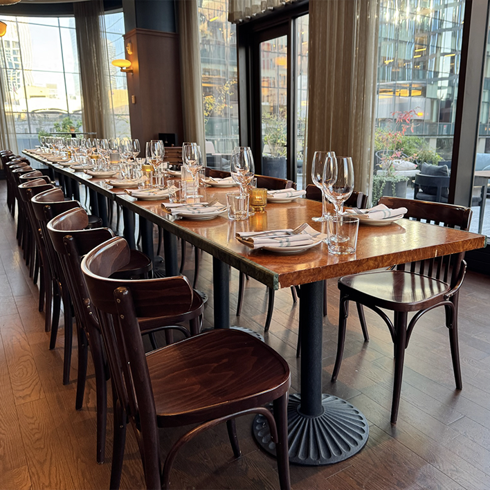 Place settings and wine glasses on Ci Siamo's copper-topped table