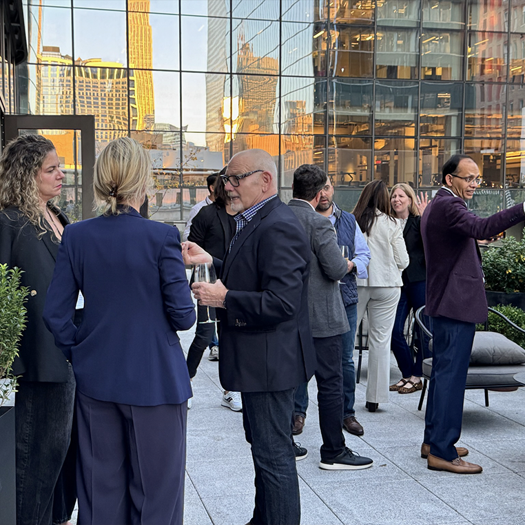 Guests mingling on the terrace at Manhattan West during golden hour