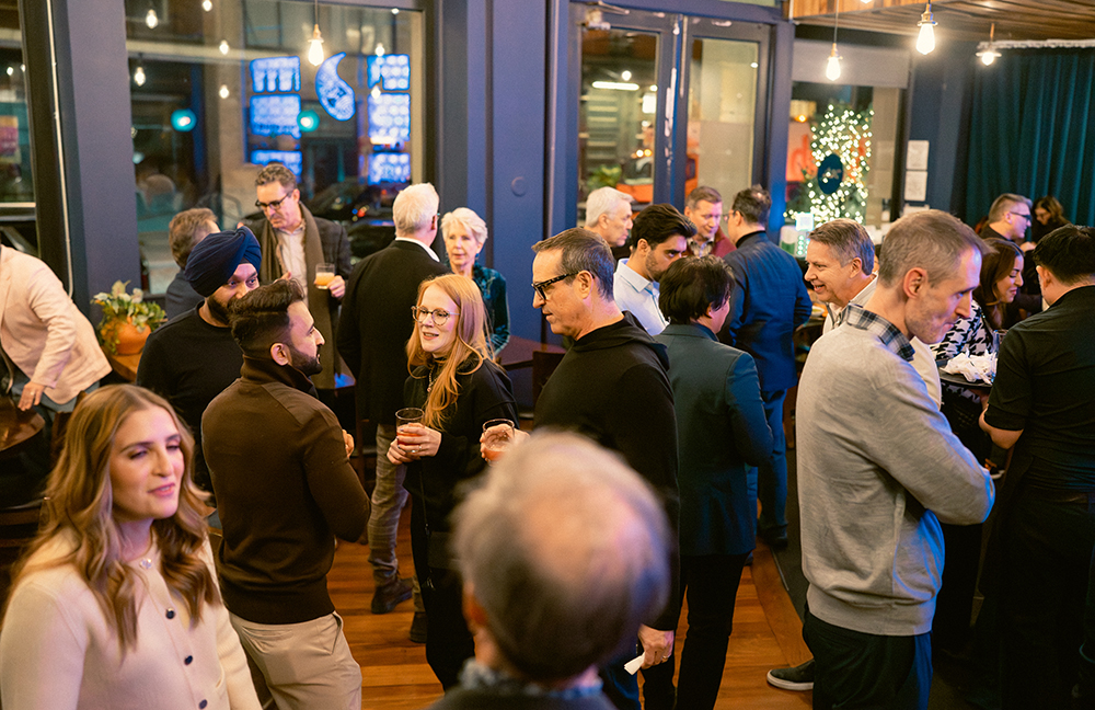 Attendees mingling across the room at Incisiv’s Happy Hour